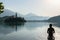 European man silhouette bathing in Bled Lake, Slovenia