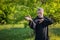 European master practicing qiqong taijiquan in the wild forest. Breathing exercise and martial art moves, traditional chinese qi e