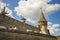 European medieval castle stone wall and tower with tents camp of some renaissance festival event, summer tine clear weather day