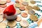 European money. Coins are on euro banknotes. Souvenir santa claus hat on money. The concept of Christmas spending in Europe, gifts