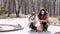 European mother and her daughter are walking with a dog during quarantine in the spring park