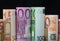 European paper money in rolls on black background