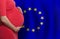 European pregnant woman belly on European Union flag background