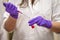 An european researcher adding toxic reagent carefully in a chemistry laboratory wearing gloves and lab coat