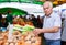 European senior buying potatoes in market