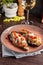 European Spanish cuisine. Baked eggplants with meat and vegetables, parmesan cheese. White wine on the table. Close-up background