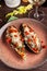 European Spanish cuisine. Baked eggplants with meat and vegetables, parmesan cheese. White wine on the table. Close-up background