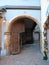 European Stone Arched Gateway with Door and Brick Path