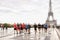 European team of runners running in Eiffel Tower background on Trocadero square, Paris.