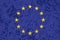 European Union flag on alphabet soup texture background.