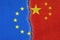 European Union flag  and Chinese flag painted on cracked wall , EU and China relations