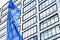 European Union flag waving in front of modern corporate office building, symbol of EU Parliament, Commission and Council