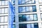 European Union flag waving in front of modern corporate office building, symbol of EU Parliament, Commission and Council