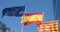 European Union, Spain and Catalonia flags waving on blue sky background. EU flag, Spanish flag and Catalonian flag