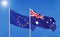 European Union vs Australia. Thick colored silky flags of European Union and Argentina. 3D illustration on sky background. -