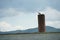 European white stork on factory chimney of old industrial building