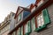 European windows with green wooden shutters in old house. Outdoors exterior