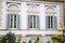 European windows with wooden shutters. Old house exterior.