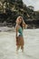 European woman in bikini swimsuit standing in ocean water