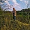 European woman on hill at spring forest