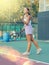 European woman serving ball while playing tennis during training