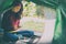 European woman in a tent overlooking the forest  holds a telephone in her hands. A modern holiday with devices