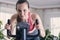 European woman training cardio work-out at home on exercise bike. Concept for weight loss. Motivated and focused young girl