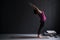 European woman on a yoga mat doing the upward salute pose.