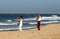 European women are engaged in a dynamic yoga on Candolim beach