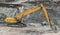 European yellow and orange excavator in action