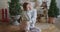 European young attractive woman in warm sweater sits in the scandinavian interior, cozy christmas home atmosphere and