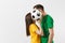 European young couple, woman man in love, football fans in yellow green t-shirt cheer up support team kissing behind