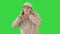 European young man calling with a medical mask on his face on a Green Screen, Chroma Key.