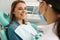 European young woman smiling while sitting in medical chair