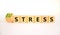 Eustress or stress symbol. Turned the wooden cube and changed the concept word Eustress to Stress. Beautiful white table white