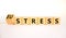 Eustress or stress symbol. Turned the wooden cube and changed the concept word Eustress to Stress. Beautiful white table white