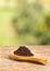 Euterpe oleracea - Organic acai powder. Wooden table in the park among the trees on a summer day. Text space
