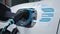 EV charger from home charging station recharging electric car. Peruse