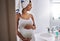Even my pregnant body looks great. a pregnant young woman standing in the bathroom at home.