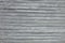 Even rows of thin shiny wire, stainless steel, bright metal background