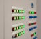 Even rows of warning lights on an electrical cabinet in red and green