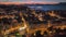 Evening aerial sunset view of Kerkyra, capital of Corfu island, Greece. Old town with illumination against background of