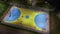 An evening aerial view of a sports ground with children practicing basketball