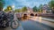 Evening in Amsterdam. Panoramic views of the famous old houses, bicycles, bridge and canal in the old center. Long exposure.