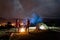 Evening camping. Man and woman standing by the campfire