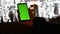 Evening Caucasian Female hands horizontally holding smartphone with green screen