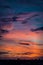 evening city landscape. silhouettes of buildings against a cloudy sky. bright colors vertical photo