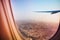 Evening cityscape of Dubai through aircraft window