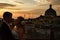 Evening clouds spread over a wedding couple standing on the roof