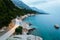 Evening coastline with rocks, trees and mountains in Brela, Croatia at the Adriatic Sea